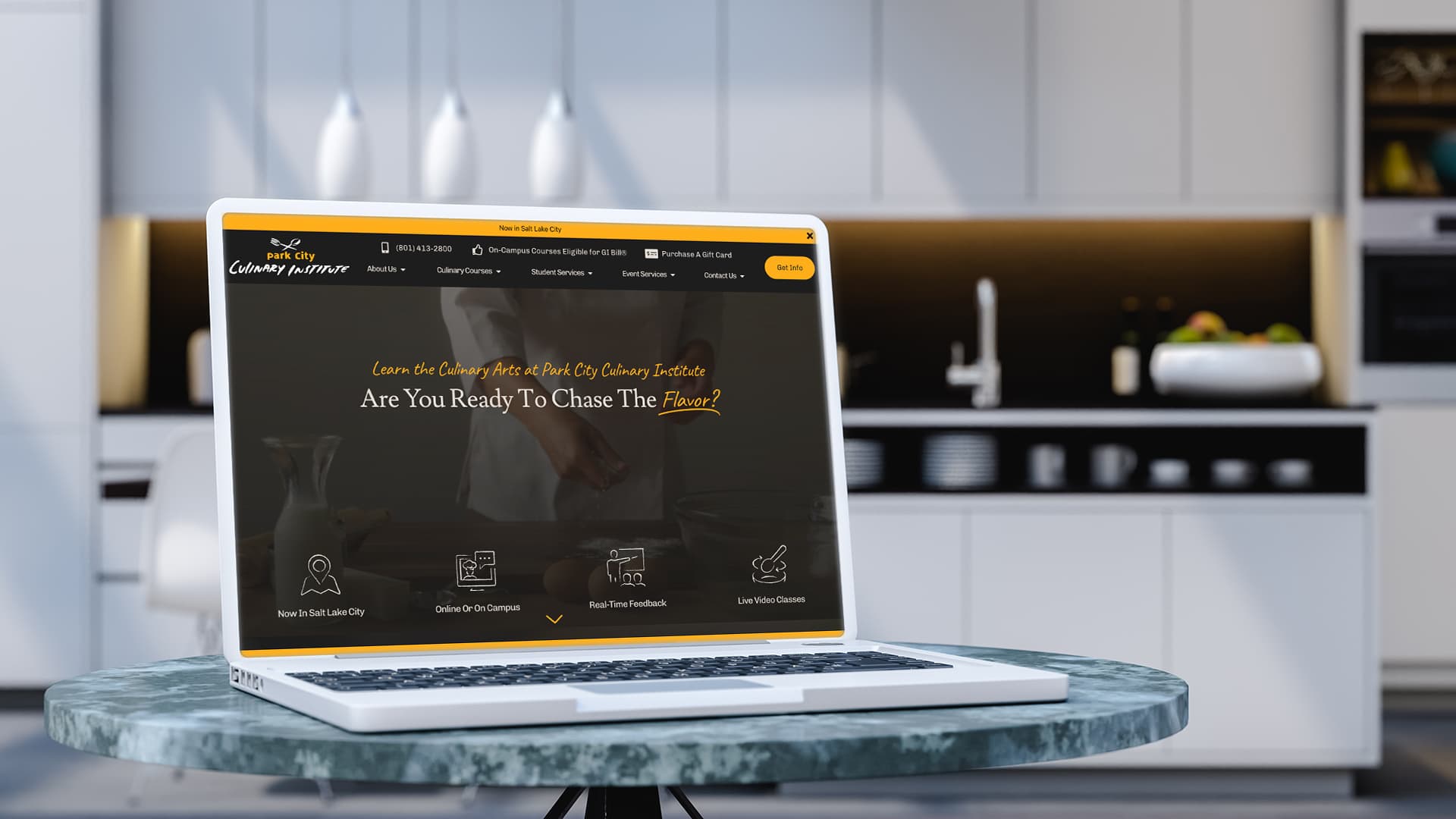The Park City Culinary Institute's homepage displayed on a laptop in a home kitchen.