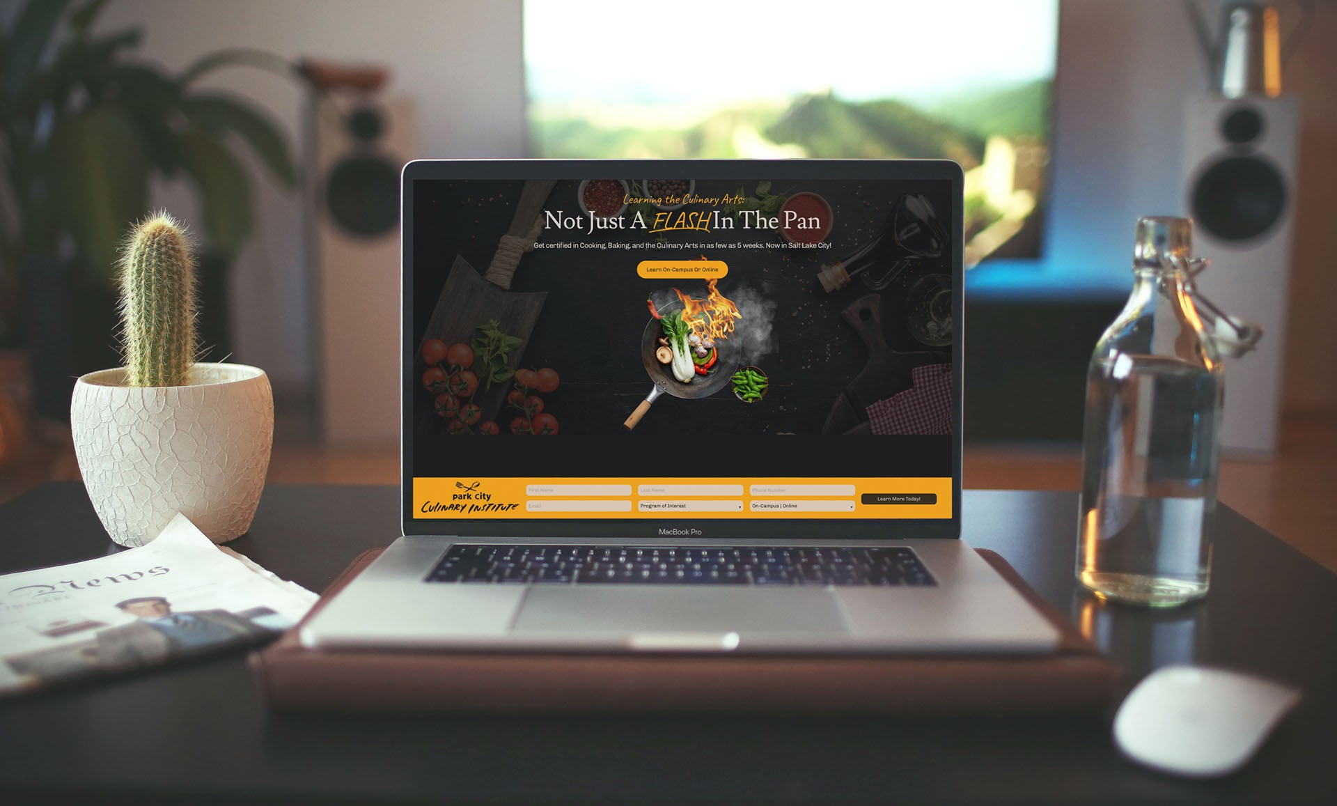 The Park City Culinary Institute landing page's hero section displayed on a laptop.