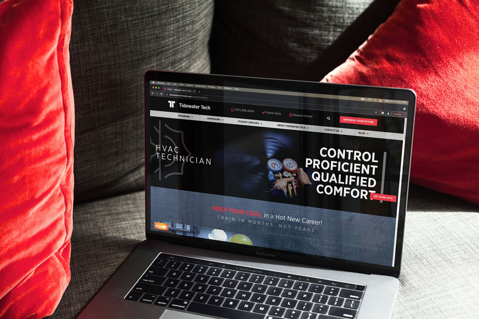 Tidewater Tech HVAC program page displayed on a laptop on a couch with red cushions.